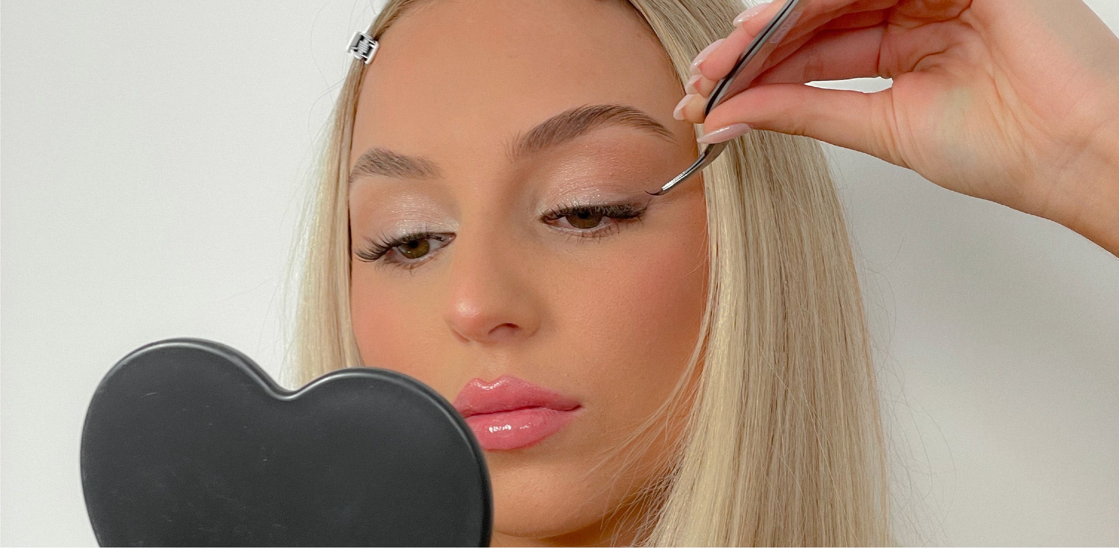 Girl applying DIY lashes