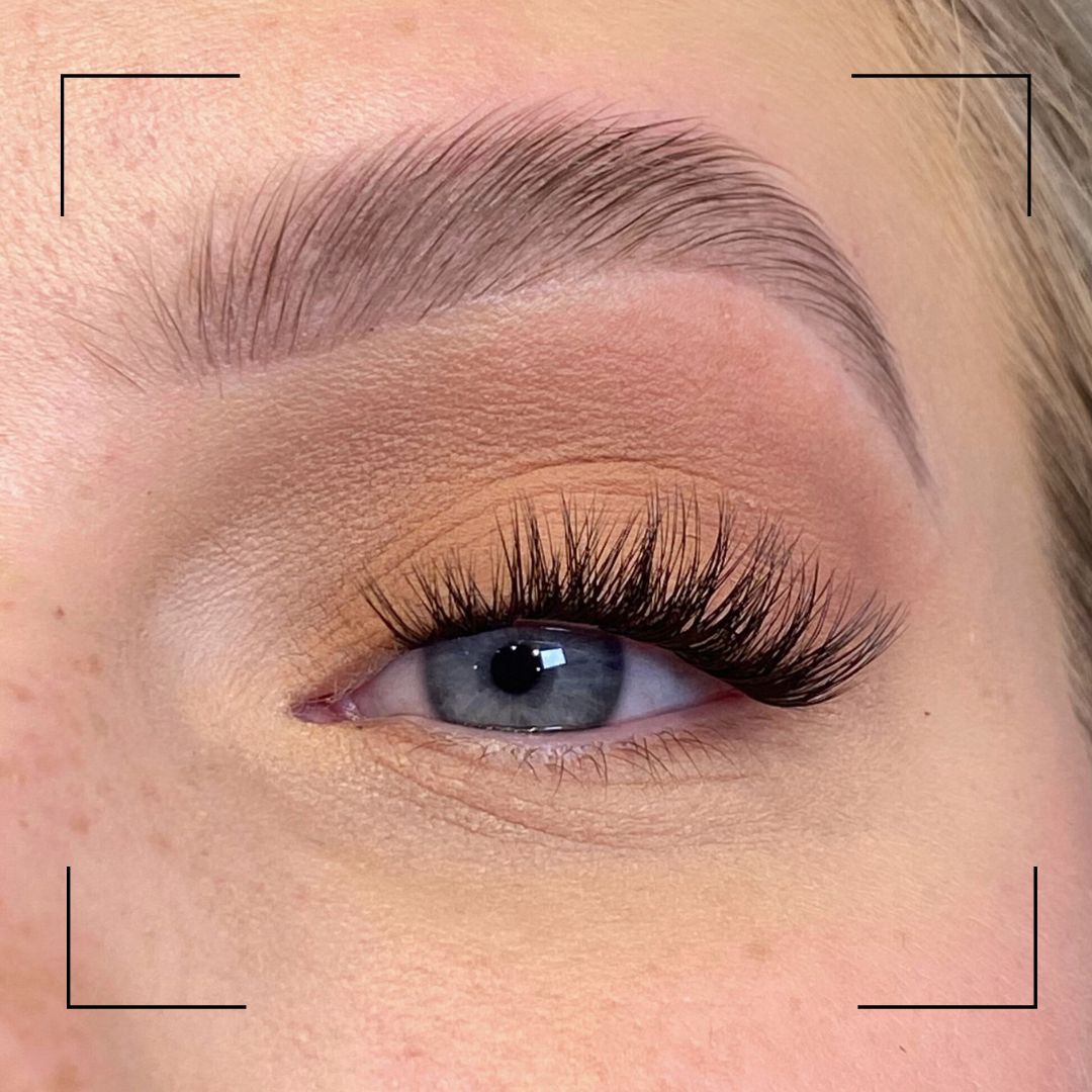 Close-up of an eye with false eyelashes and a blurred background