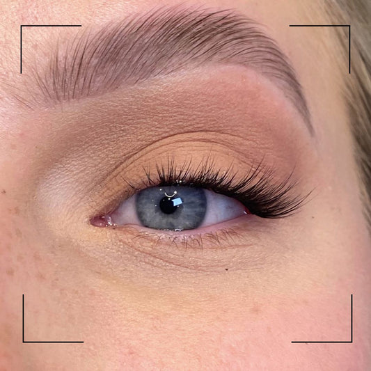 Close-up of a person's eye with long eyelashes