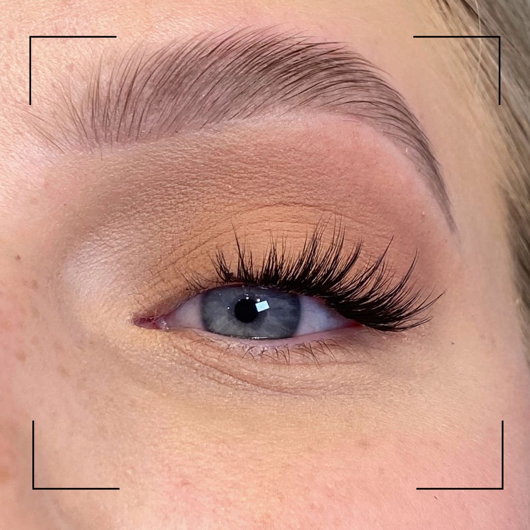 Close-up of an eye with long eyelashes and a blurred background